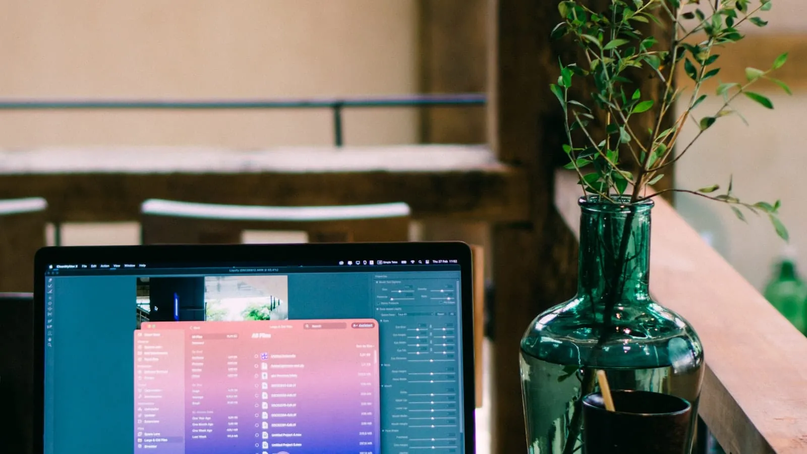 Minimal workspace with laptop and coffee on a sunlit wooden desk